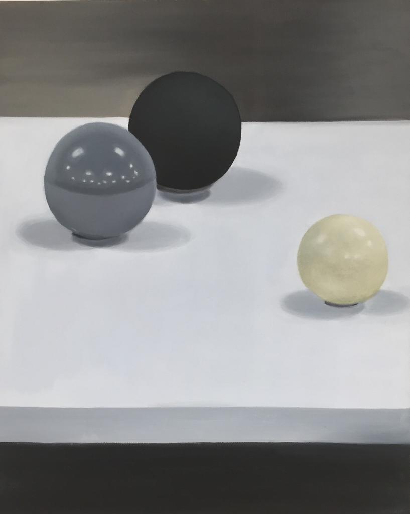 A still life painting of black, white and, grey ball on a table